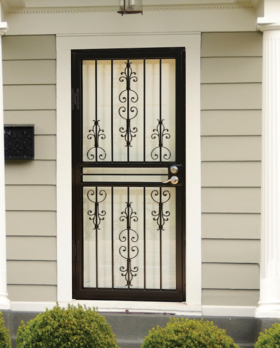 bronze-security-storm-door-ornamental-scrollwork Bronze security storm door with ornamental scrollwork and vertical bars on a home entrance